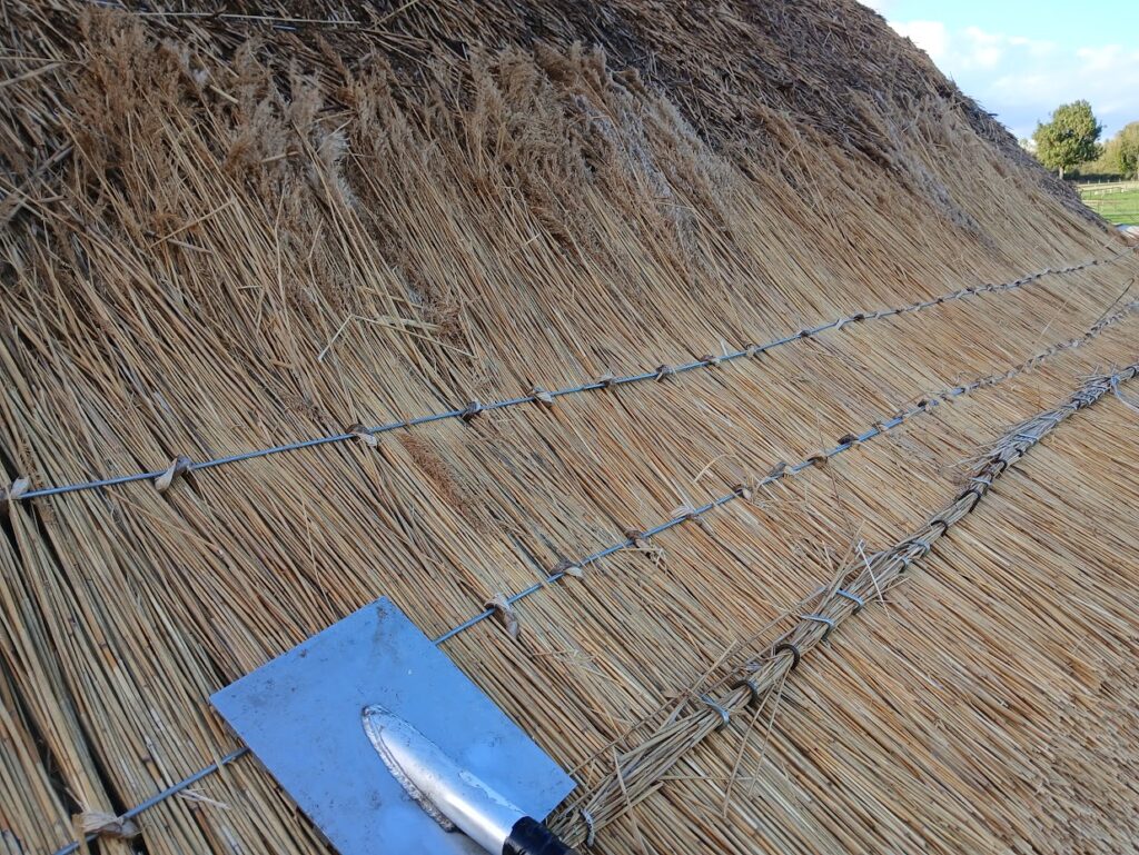 Traditional Thatched roof eing rethatched in Ireland